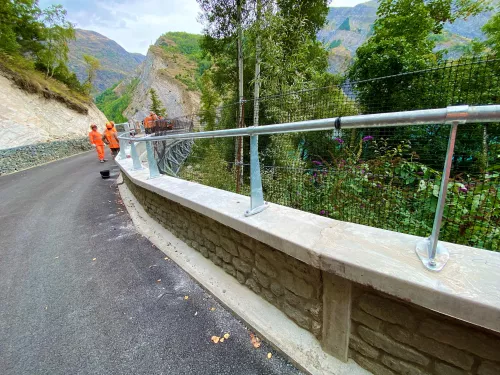 Greenway with concrete pavement and installation of a guardrail